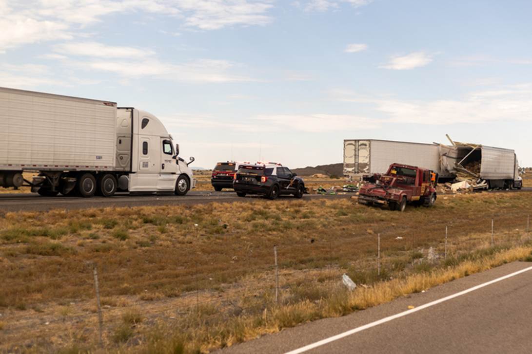 This image is part of a website article about truck accident risks, and shows a highway accident involving trucks and cars.